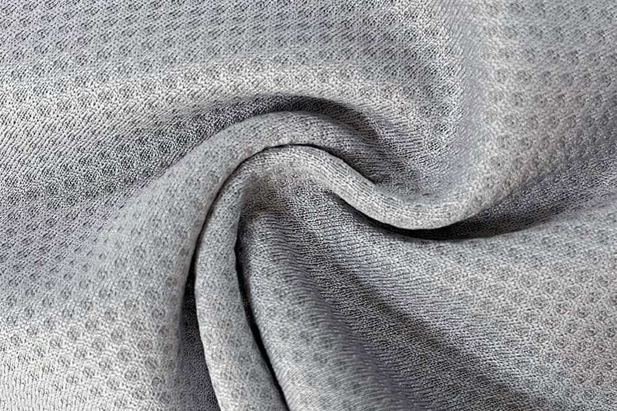 Tejido de panal de malla jacquard monocromático que absorbe el agua y da sensación de frescura